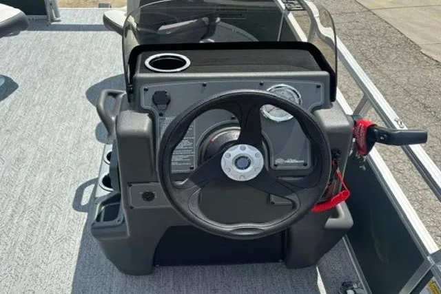 Slide: The Image of 2026 Sun Tracker Bass Buggy 16 XL Select steering console with cup holder and controls. - 11