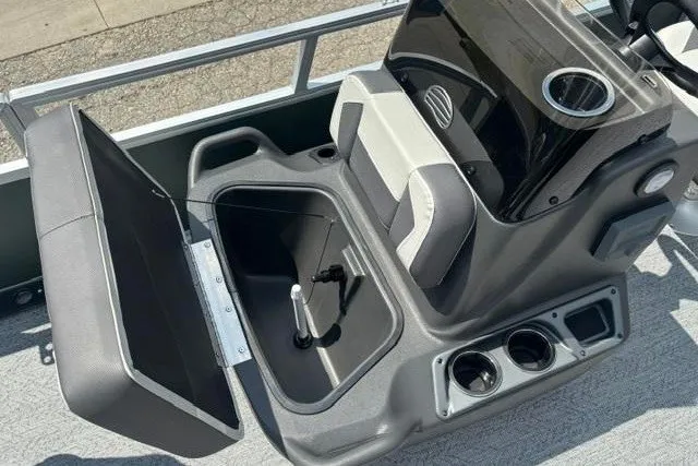 Slide: The Image of 2026 Sun Tracker Bass Buggy 16 XL Select boat interior with open storage compartment and cup holders. - 10