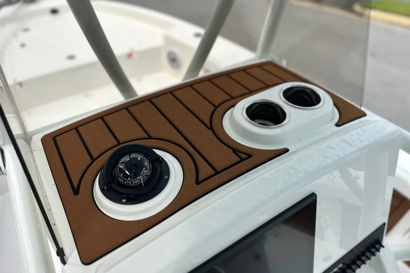 Slide: The Image of 2027 Pathfinder 2400 Tournament boat dashboard with compass and cup holders. - 15