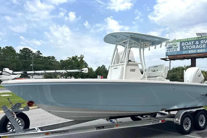 Slide: The Image of 2027 Pathfinder 2400 Tournament boat on trailer, displayed outdoors under a clear sky. - 21