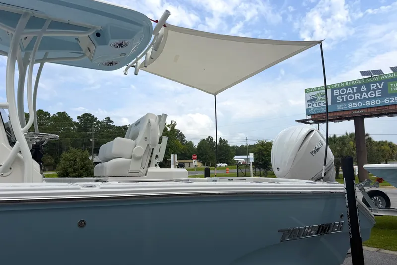 Slide: The Image of 2027 Pathfinder 2400 Tournament boat with canopy, displayed outdoors near storage facility. - 35