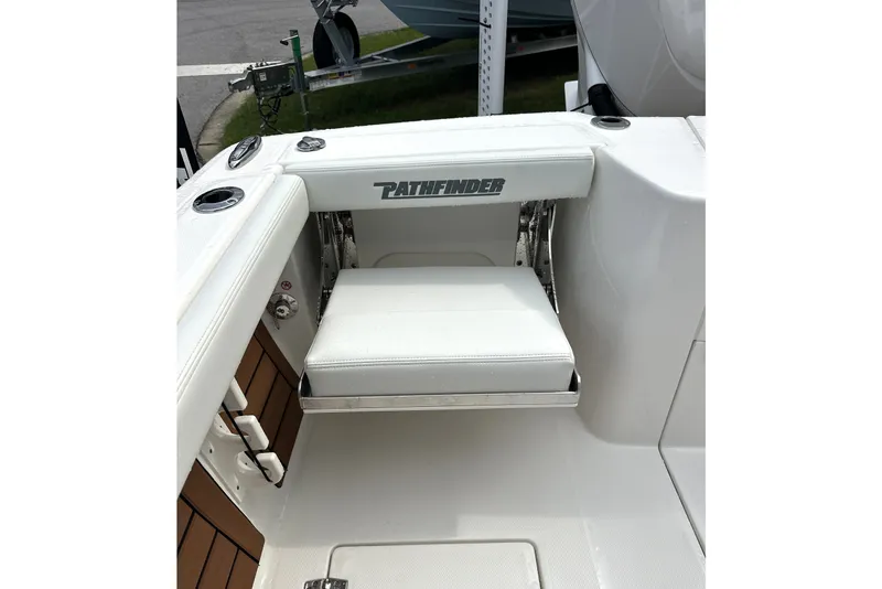 Slide: The Image of Pathfinder 2400 Tournament 2027 boat seat with logo, white upholstery, and cup holders. - 8