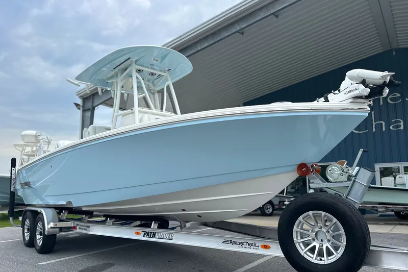 Slide: The Image of 2027 Pathfinder 2400 Tournament boat on trailer, light blue hull, parked outdoors. - 3