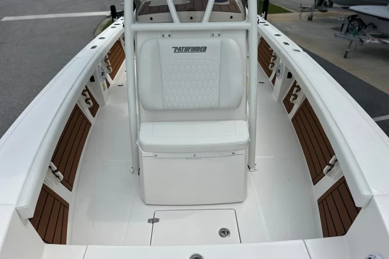 Slide: The Image of 2027 Pathfinder 2400 Tournament boat interior with white seating and wood accents. - 13