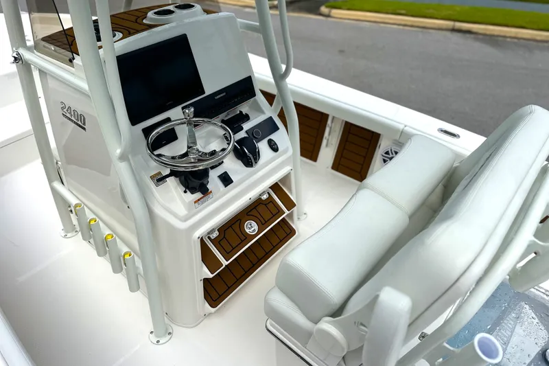 Slide: The Image of 2027 Pathfinder 2400 Tournament boat interior with steering console and seating. - 17