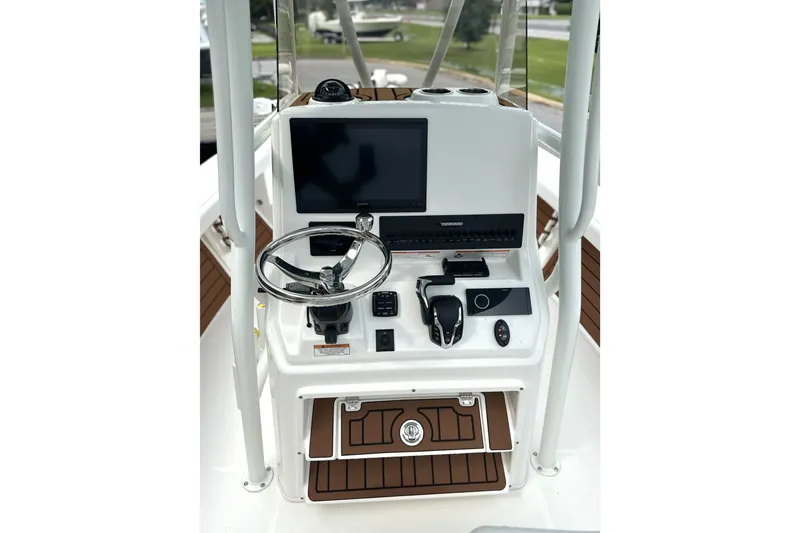 Slide: The Image of Steering console of 2027 Pathfinder 2400 Tournament boat with modern controls and display. - 16