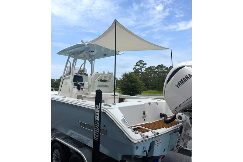 Slide: The Image of Pathfinder 2400 Tournament 2027 boat with Yamaha engine and canopy, parked on trailer. - 34