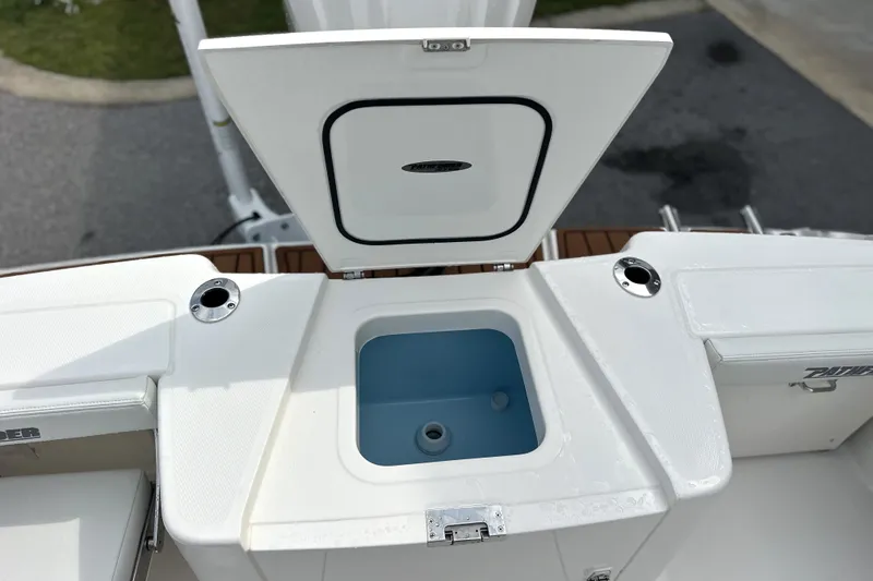 Slide: The Image of 2027 Pathfinder 2400 Tournament boat with open storage compartment and rod holders. - 6
