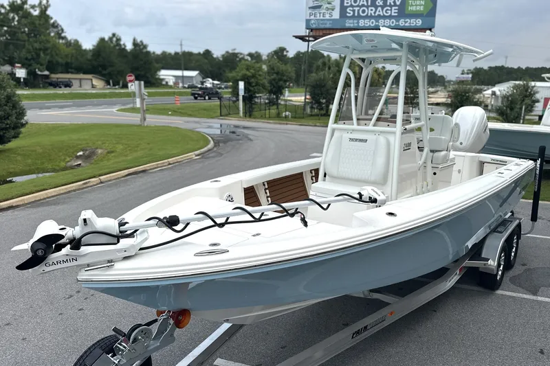 Slide: The Image of 2027 Pathfinder 2400 Tournament boat on trailer, featuring Garmin equipment, parked near storage facility. - 20