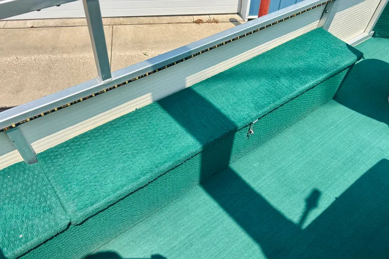 Slide: The Image of Green carpeted seating area on a 2003 Misty Harbor 2080CF boat. - 41
