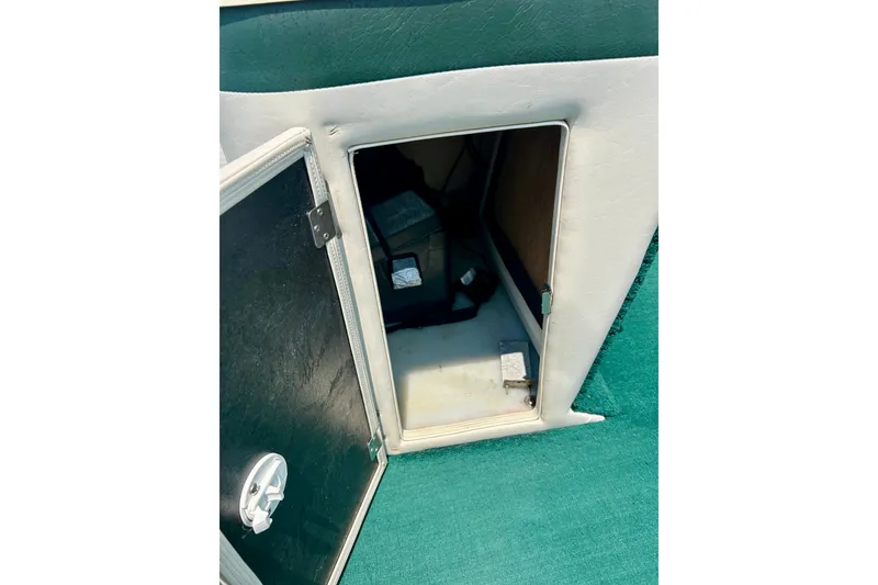 Slide: The Image of Open storage compartment in 2003 Misty Harbor 2080CF boat with green carpet interior. - 45