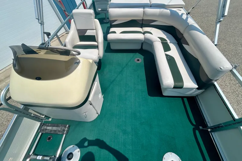 Slide: The Image of 2003 Misty Harbor 2080CF pontoon boat interior with green carpet and white seating. - 43