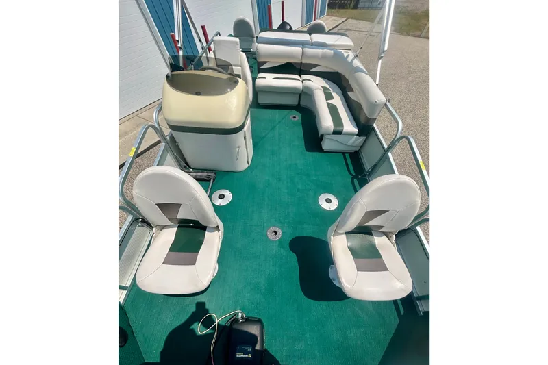 Slide: The Image of 2003 Misty Harbor 2080CF pontoon boat interior with green carpet and white seating. - 14