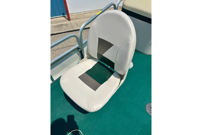 Slide: The Image of White and gray boat seat on a 2003 Misty Harbor 2080CF, green carpet background. - 15
