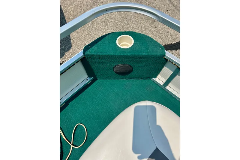 Slide: The Image of 2003 Misty Harbor 2080CF boat interior with green carpet and cup holder. - 18