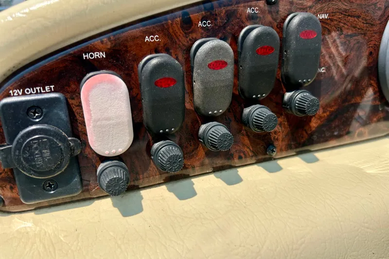 Slide: The Image of Control panel of a 2003 Misty Harbor 2080CF boat with switches and 12V outlet. - 23