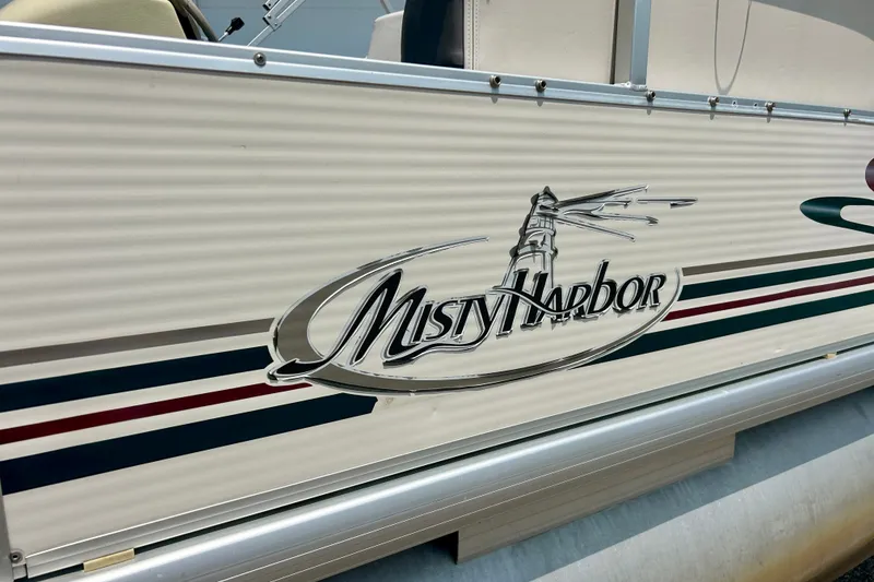 Slide: The Image of 2003 Misty Harbor 2080CF boat with logo and lighthouse graphic on the side. - 7