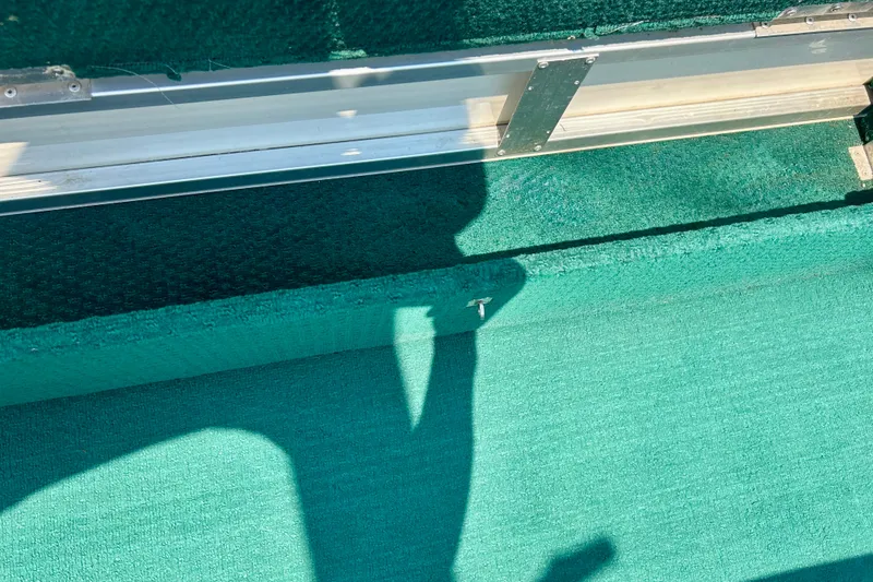 Slide: The Image of Green carpeted interior of a 2003 Misty Harbor 2080CF boat. - 42