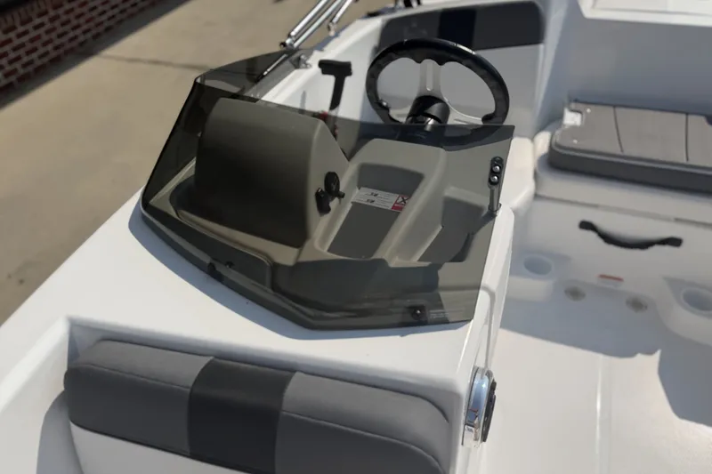 Slide: The Image of 2027 Tahoe T16 boat cockpit with steering wheel and seating area. - 8