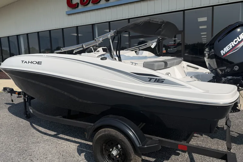 Slide: The Image of 2027 Tahoe T16 boat with Mercury engine on trailer, parked outside a building. - 4