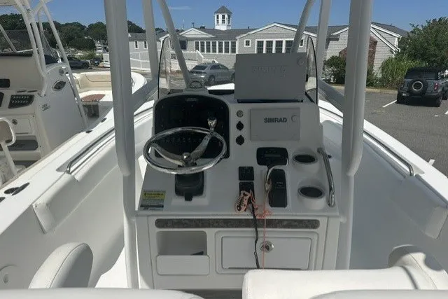 Slide: The Image of 2013 Sea Hunt Ultra 234 boat console with steering wheel and navigation equipment. - 3