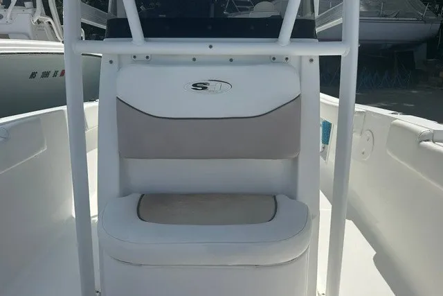 Slide: The Image of 2013 Sea Hunt Ultra 234 boat interior with cushioned seating and console. - 10
