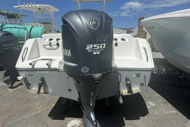 Slide: The Image of 2013 Sea Hunt Ultra 234 boat with Yamaha 250 V6 engine, parked outdoors. - 13