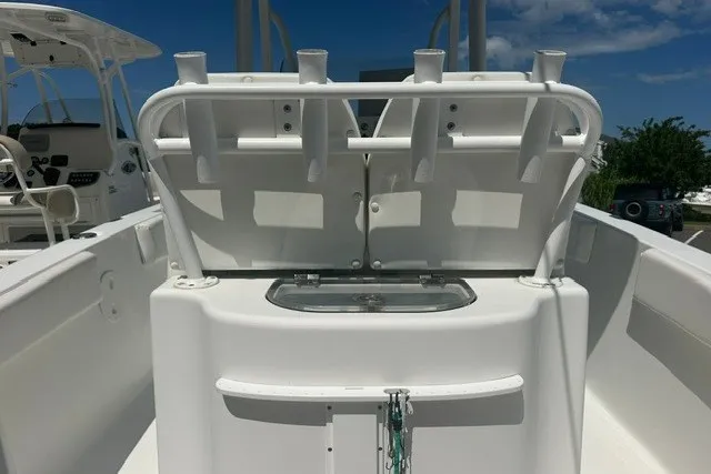 Slide: The Image of 2013 Sea Hunt Ultra 234 boat interior with rod holders and storage compartment. - 8