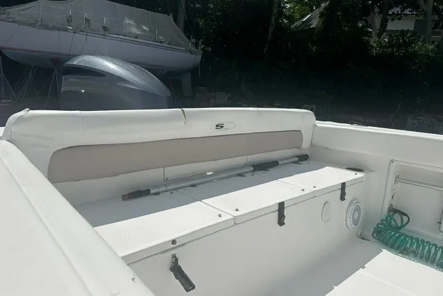 Slide: The Image of 2013 Sea Hunt Ultra 234 boat interior with seating and storage compartments. - 12