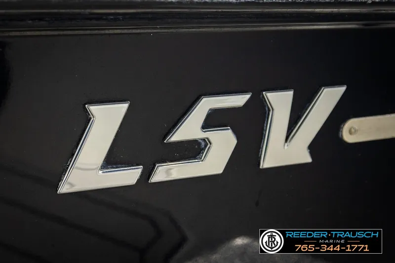 Slide: The Image of 2017 Malibu Wakesetter 25 LSV logo on black surface, Reeder Trausch Marine contact info. - 61