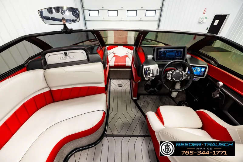 Slide: The Image of 2017 Malibu Wakesetter 25 LSV interior with red and white seating, modern dashboard. - 15