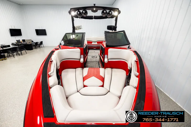 Slide: The Image of 2017 Malibu Wakesetter 25 LSV boat interior with red and white seating in showroom. - 17
