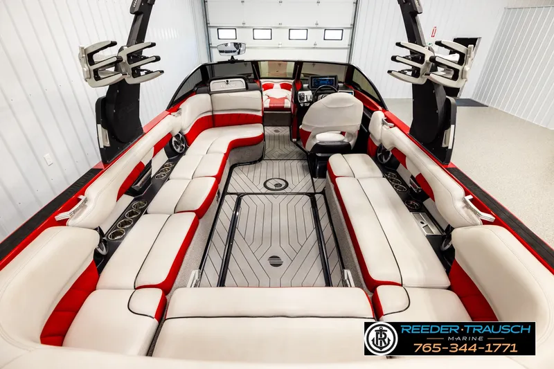 Slide: The Image of 2017 Malibu Wakesetter 25 LSV interior with red and white seating, spacious layout. - 14