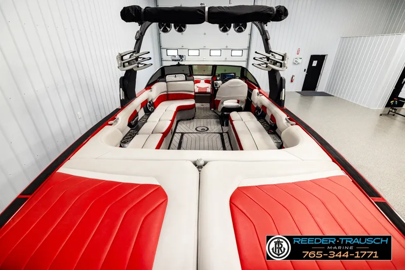Slide: The Image of 2017 Malibu Wakesetter 25 LSV interior with red and white seating in showroom. - 13