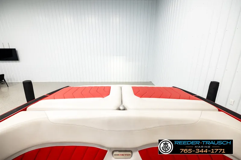 Slide: The Image of 2017 Malibu Wakesetter 25 LSV boat interior with red and white seating in showroom. - 20