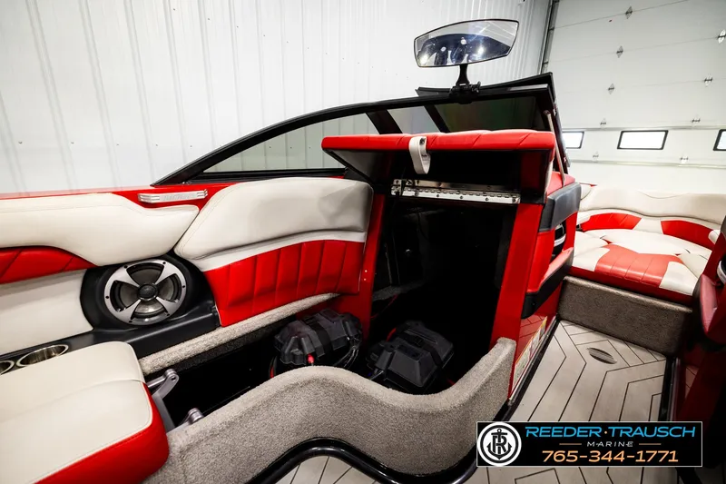 Slide: The Image of 2017 Malibu Wakesetter 25 LSV interior with red and white seating, speaker, and storage. - 31