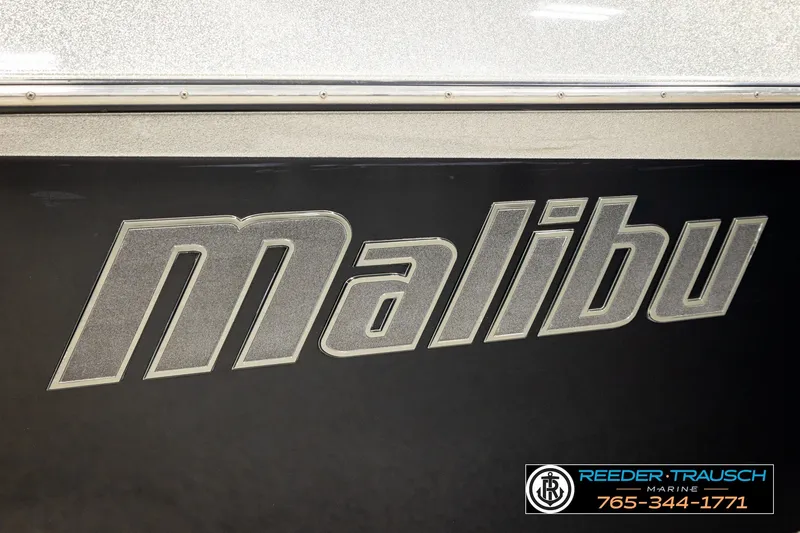 Slide: The Image of 2017 Malibu Wakesetter 25 LSV logo on boat exterior, Reeder Trausch Marine contact info. - 59