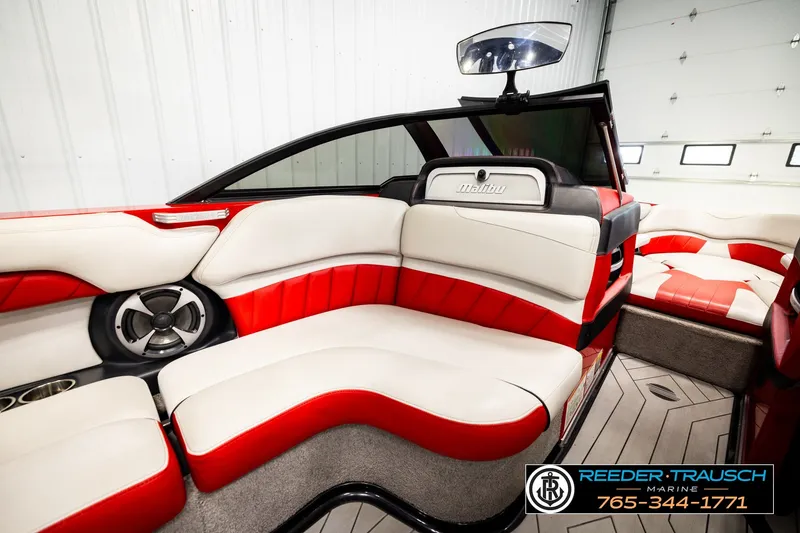 Slide: The Image of 2017 Malibu Wakesetter 25 LSV interior with red and white seating, luxury design. - 30