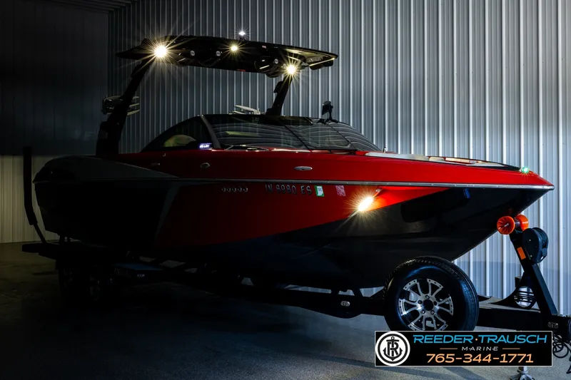 Slide: The Image of 2017 Malibu Wakesetter 25 LSV boat in a dimly lit garage with trailer. - 4
