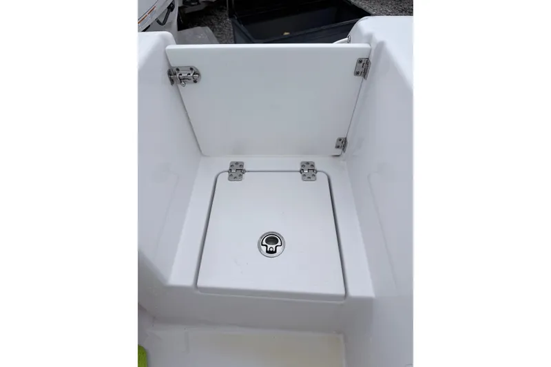 Slide: The Image of 2024 Sportsman Open 232 Center Console storage compartment with secure latch and hinges. - 9