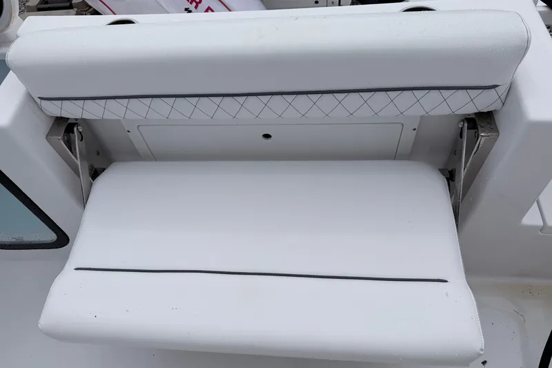 Slide: The Image of 2024 Sportsman Open 232 Center Console boat seat with white cushioned design. - 10