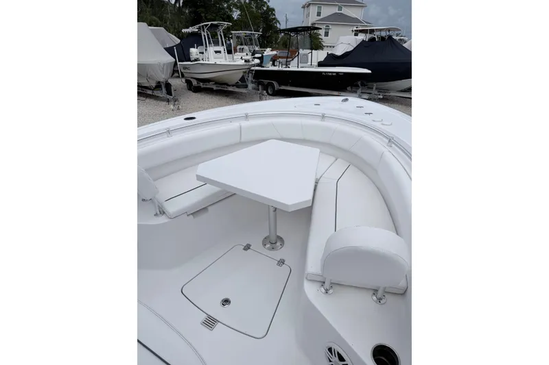 Slide: The Image of 2024 Sportsman Open 232 Center Console boat interior with seating and table. - 21