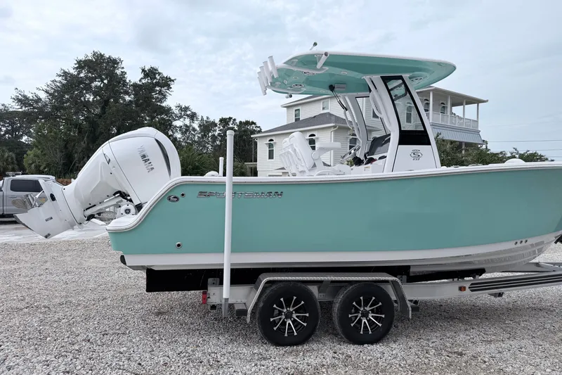 Slide: The Image of 2024 Sportsman Open 232 Center Console boat on trailer, featuring Yamaha engine. - 4