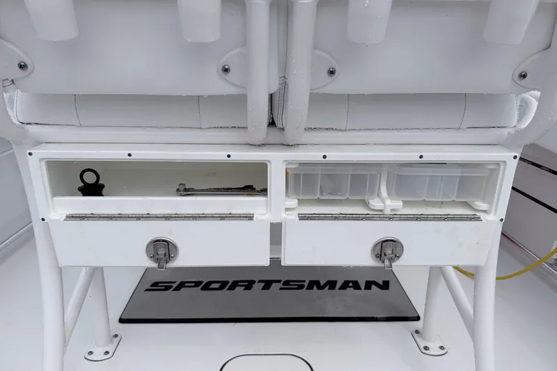 Slide: The Image of 2024 Sportsman Open 232 Center Console storage compartments with tackle boxes and tools. - 11