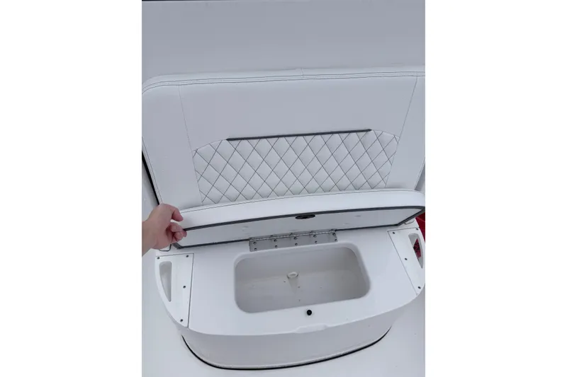 Slide: The Image of 2024 Sportsman Open 232 Center Console boat seat storage compartment open. - 23