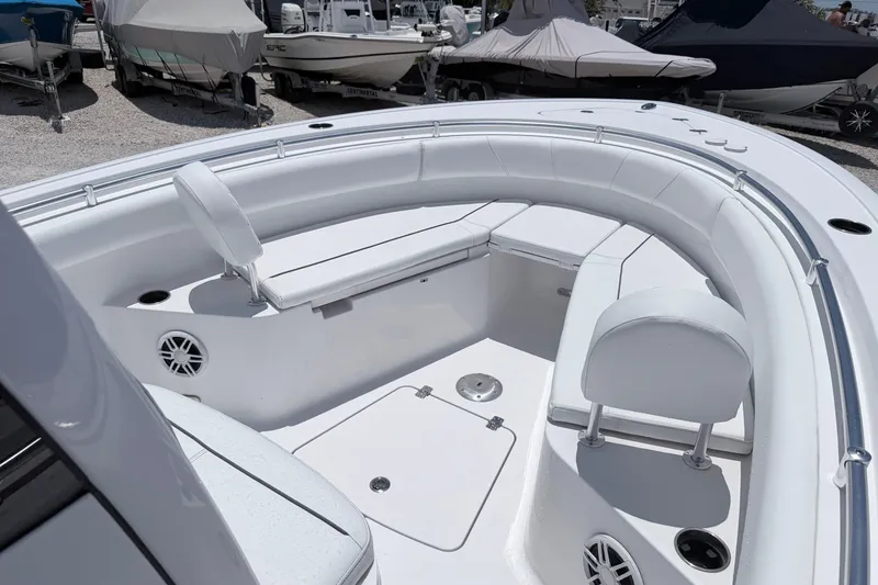 Slide: The Image of 2024 Sportsman Open 232 Center Console boat interior with white seating and storage compartments. - 4
