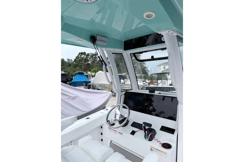 Slide: The Image of 2024 Sportsman Open 232 Center Console boat interior with modern helm and controls. - 13