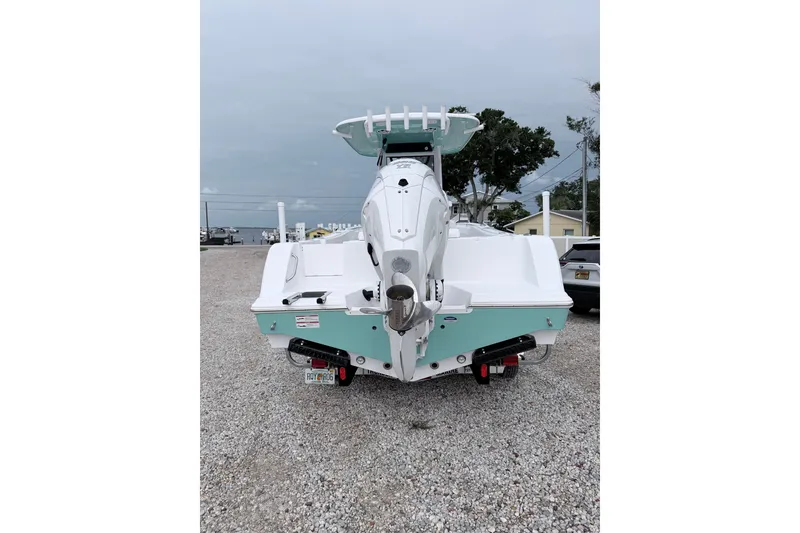 Slide: The Image of 2024 Sportsman Open 232 Center Console boat, rear view on gravel lot. - 6