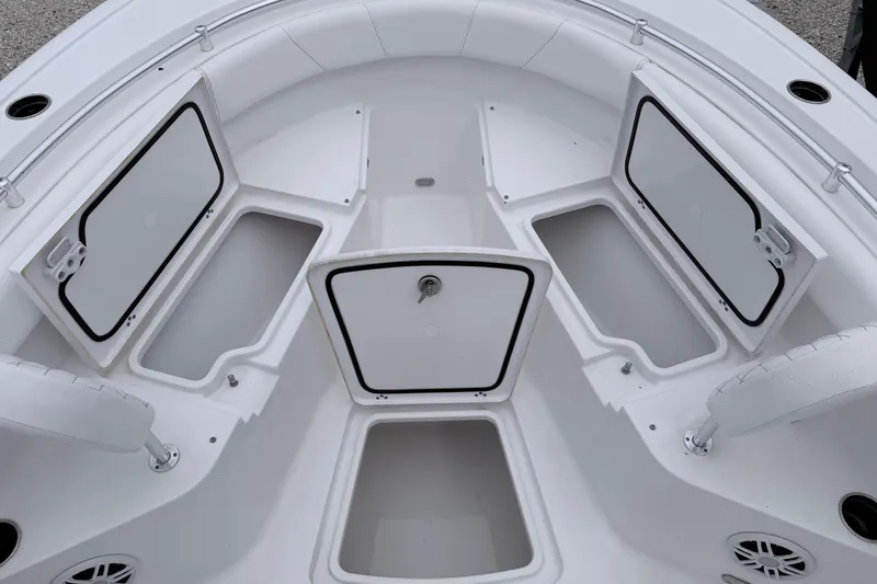 Slide: The Image of 2024 Sportsman Open 232 Center Console boat storage compartments open, showcasing spacious design. - 20
