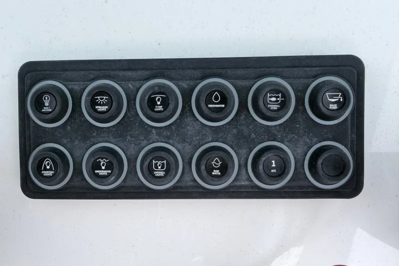 Slide: The Image of Control panel of a 2024 Sportsman Open 232 Center Console boat with labeled buttons. - 16
